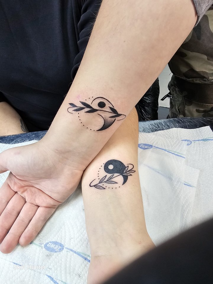 Kleine Motive mit Vögeln und Yin-Yang an zwei Handgelenken